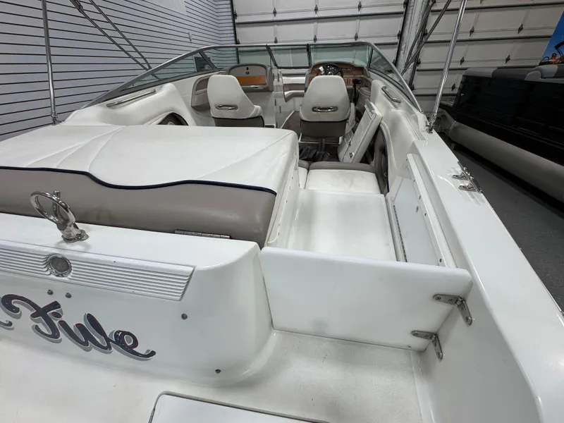 Slide: The Image of 2001 Cobalt 246 boat interior with white seating and steering wheel in a garage setting. - 5