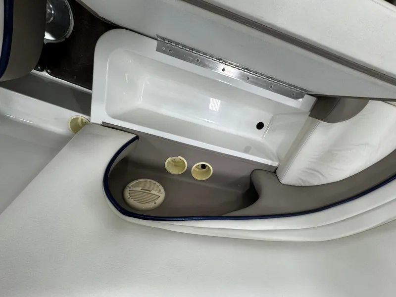 Slide: The Image of Interior of a 2001 Cobalt 246 boat, featuring white and gray seating. - 8