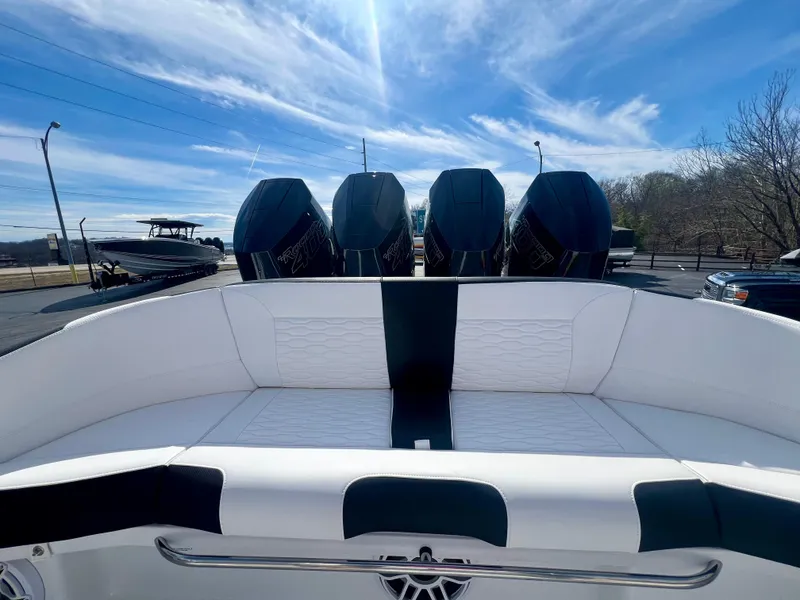 Slide: The Image of 2025 Nor-Tech 390 Sport Center Console with four powerful outboard engines, under a clear blue sky. - 17