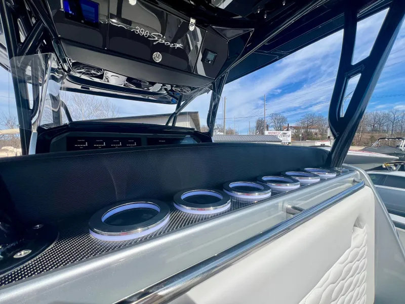 Slide: The Image of 2025 Nor-Tech 390 Sport Center Console interior with sleek design and cup holders. - 19