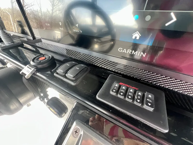 Slide: The Image of 2025 Nor-Tech 390 Sport Center Console dashboard with Garmin navigation system and controls. - 34