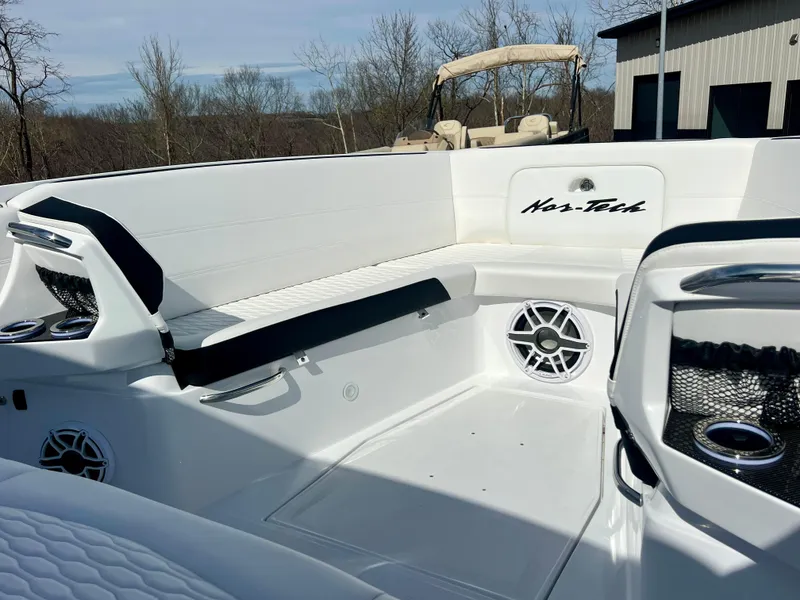 Slide: The Image of 2025 Nor-Tech 390 Sport Center Console boat interior with seating and speakers. - 40