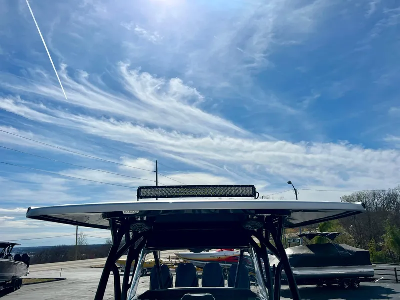 Slide: The Image of 2025 Nor-Tech 390 Sport Center Console under a bright blue sky with wispy clouds. - 48