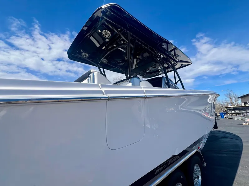 Slide: The Image of 2025 Nor-Tech 390 Sport Center Console boat under a clear blue sky. - 5