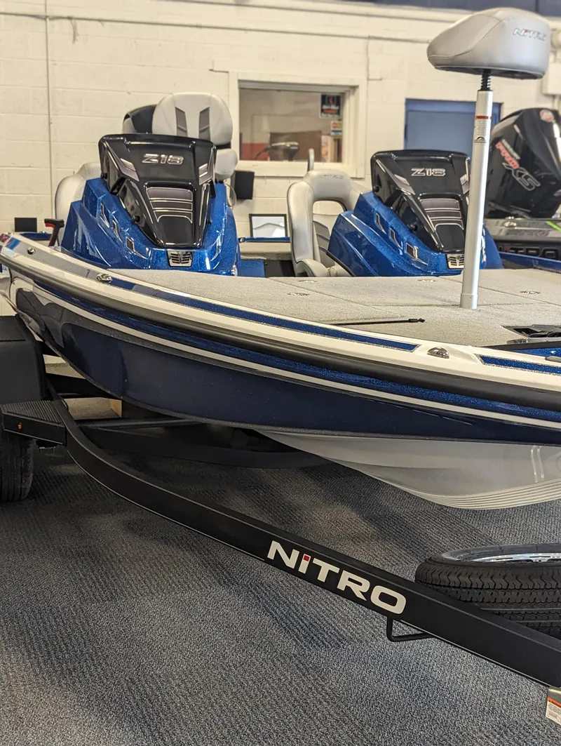 Slide: The Image of 2024 Nitro Z18Pro boat in showroom, featuring sleek blue design and advanced seating. - 15
