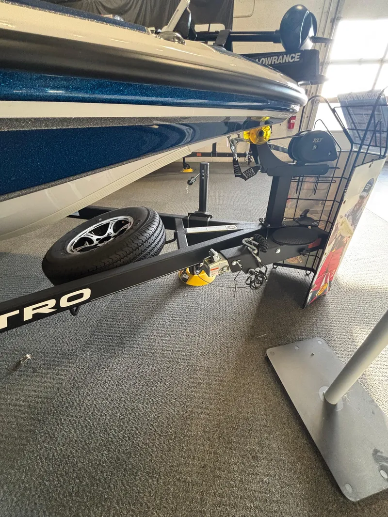 Slide: The Image of 2024 Nitro Z18Pro boat trailer with spare tire and Lowrance equipment in showroom. - 8