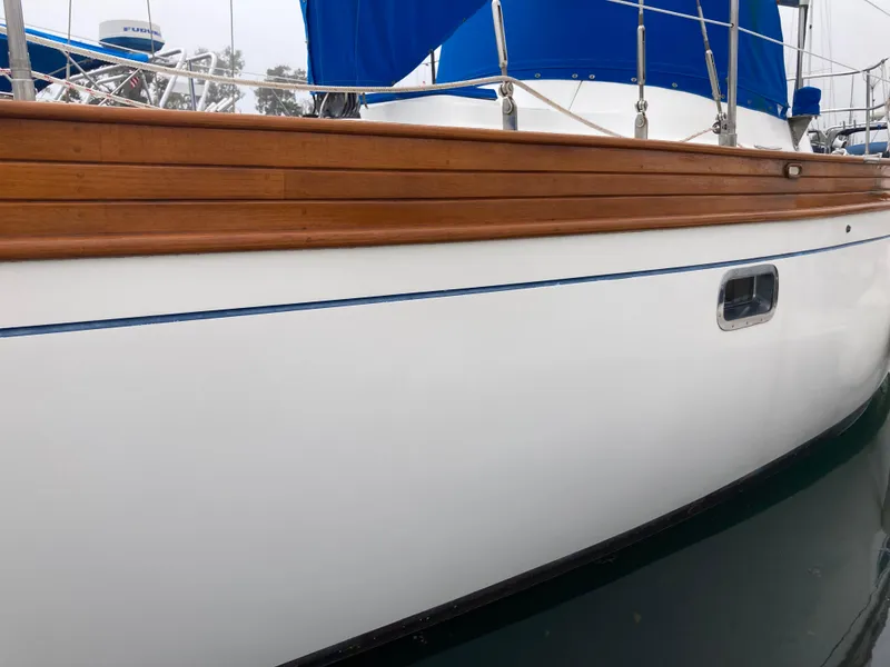 Slide: The Image of 1984 Nantucket Island 33 sailboat with wooden trim and blue accents. - 11