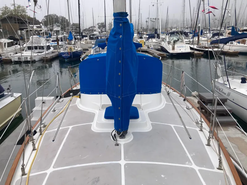 Slide: The Image of Sailboat deck view, Nantucket Island 33, 1984, docked in a marina with blue sail cover. - 15