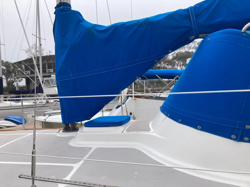 Slide: The Image of Sailboat deck with blue covers, Nantucket Island 33, 1984 model, docked at marina. - 16