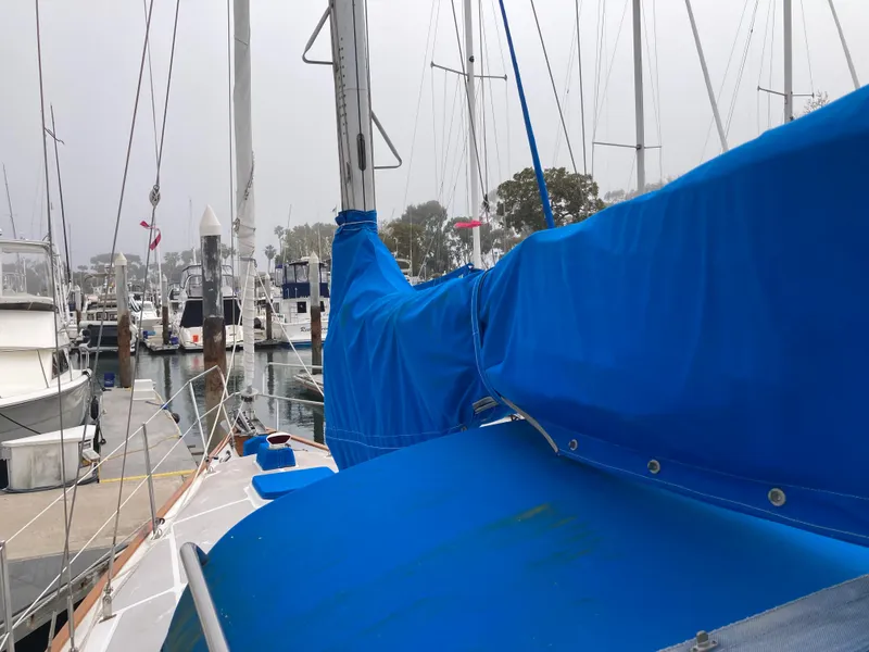 Slide: The Image of Sailboat docked in marina, Nantucket Island 33, 1984 model, with blue sail cover. - 17