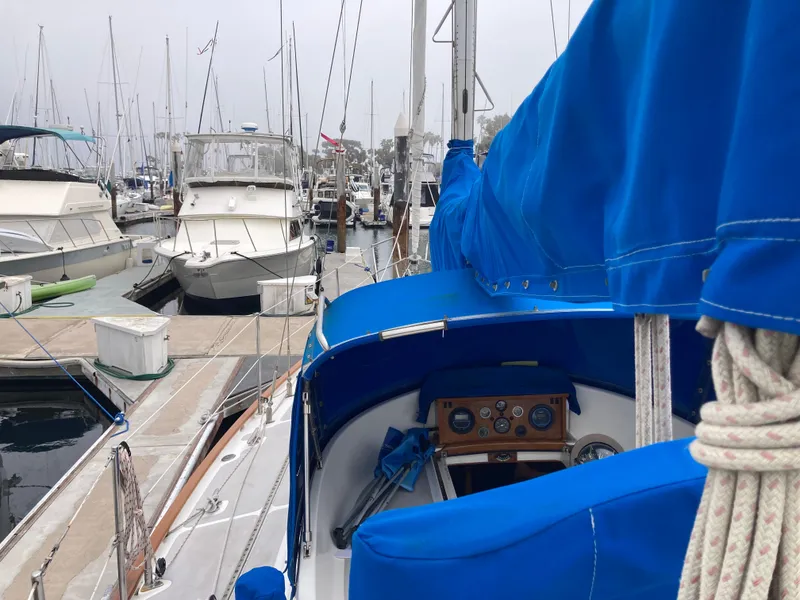 Slide: The Image of Sailboat with blue cover docked in marina, surrounded by other boats. Nantucket Island 33, 1984. - 18