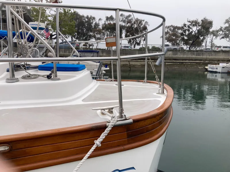 Slide: The Image of 1984 Nantucket Island 33 boat docked, featuring wooden trim and metal railings. - 22