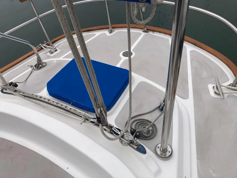 Slide: The Image of Deck of 1984 Nantucket Island 33 sailboat with blue cushion and stainless steel fittings. - 27