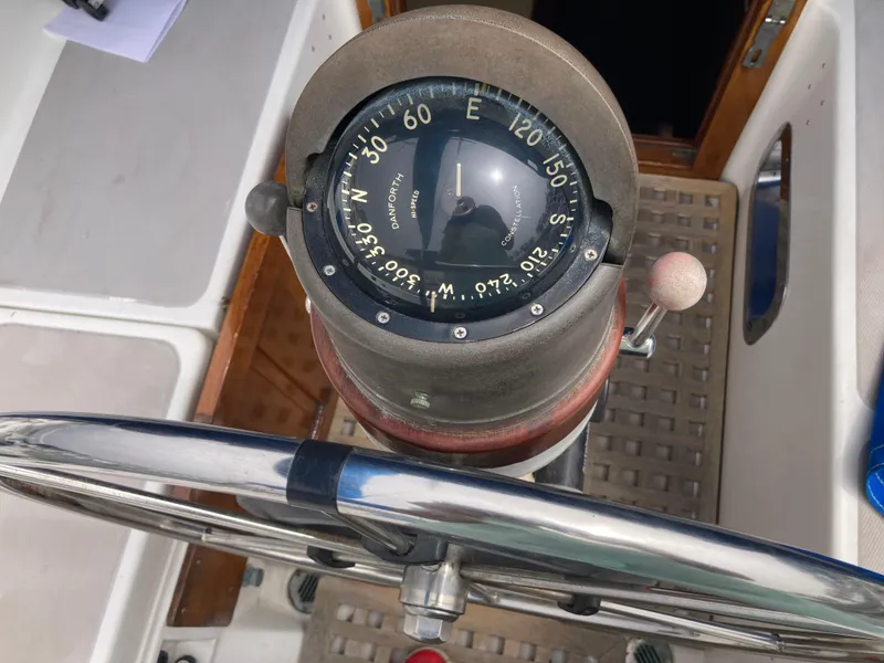 Slide: The Image of Compass and steering wheel on a 1984 Nantucket Island 33 sailboat. - 32