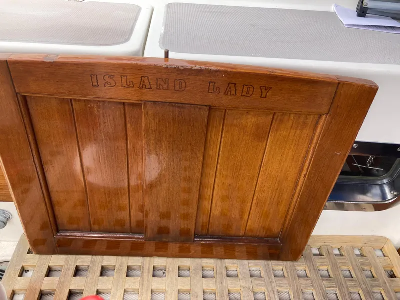 Slide: The Image of Wooden panel on Nantucket Island 33 boat, engraved with "Island Lady," 1984 model. - 33