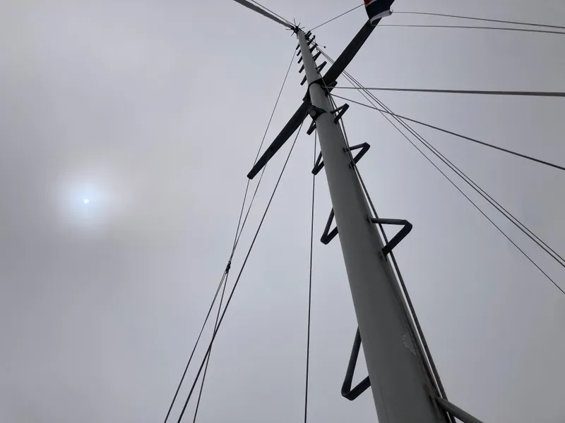 Slide: The Image of Sailboat mast against cloudy sky, Nantucket Island 33, 1984 model. - 36