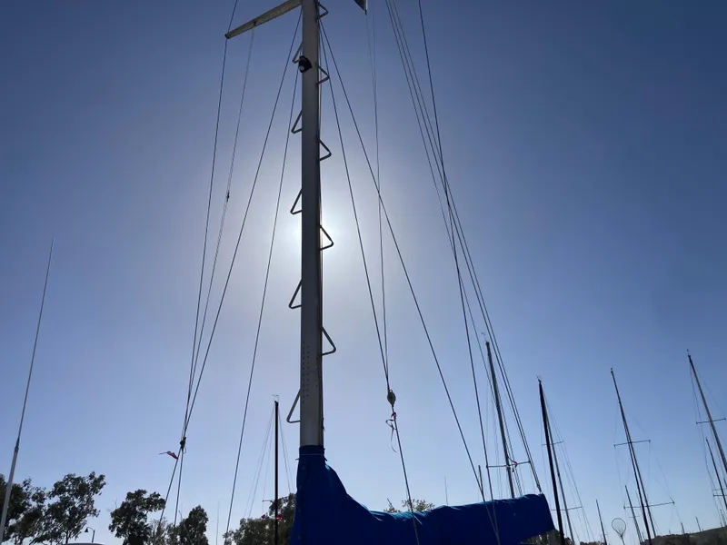 Slide: The Image of Sailboat mast silhouetted against the sun, Nantucket Island 33, 1984 model. - 37