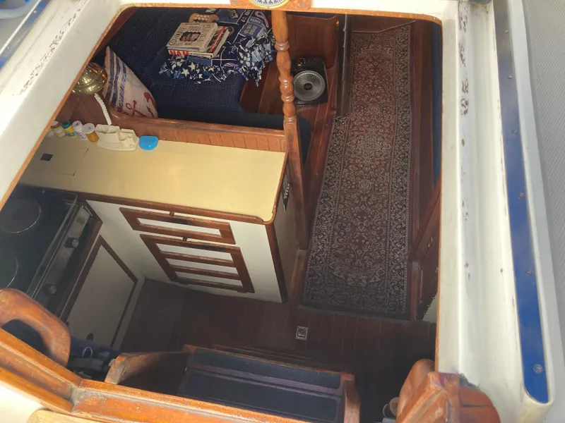 Slide: The Image of Interior view of a 1984 Nantucket Island 33 boat, featuring a cozy cabin space. - 38