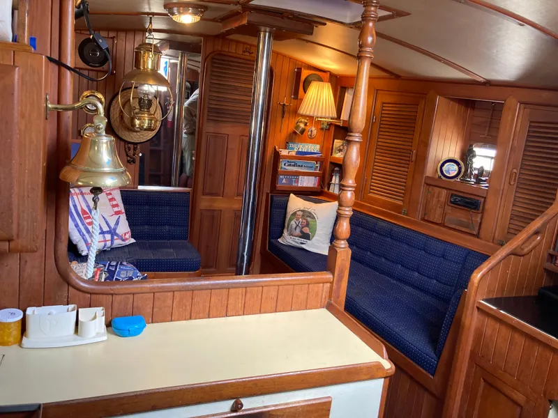 Slide: The Image of Cozy 1984 Nantucket Island 33 yacht interior with wood paneling and blue seating. - 39