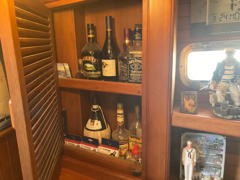 Slide: The Image of Wooden cabinet with assorted liquor bottles and nautical decor on a Nantucket Island 33, 1984. - 47