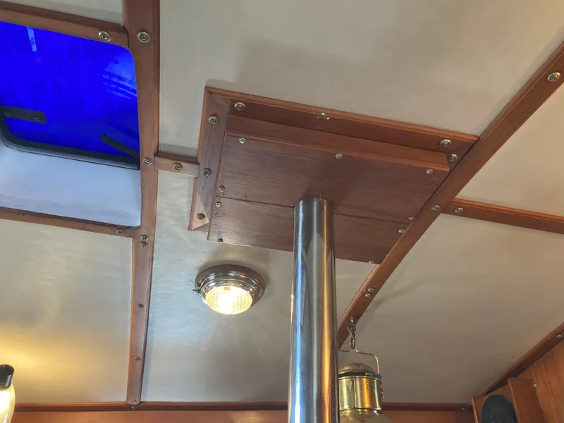 Slide: The Image of Interior ceiling of 1984 Nantucket Island 33 boat with wooden beams and lighting. - 48