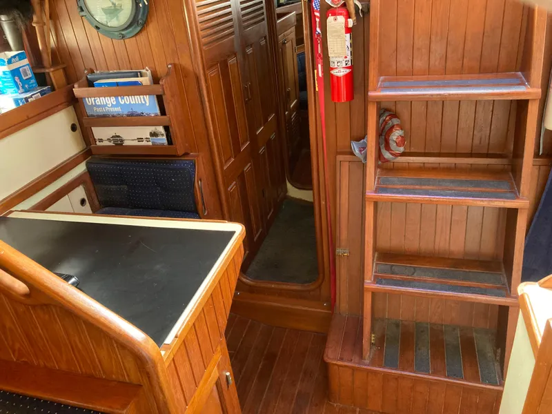 Slide: The Image of Interior of a 1984 Nantucket Island 33 sailboat with wooden cabinetry and nautical decor. - 56
