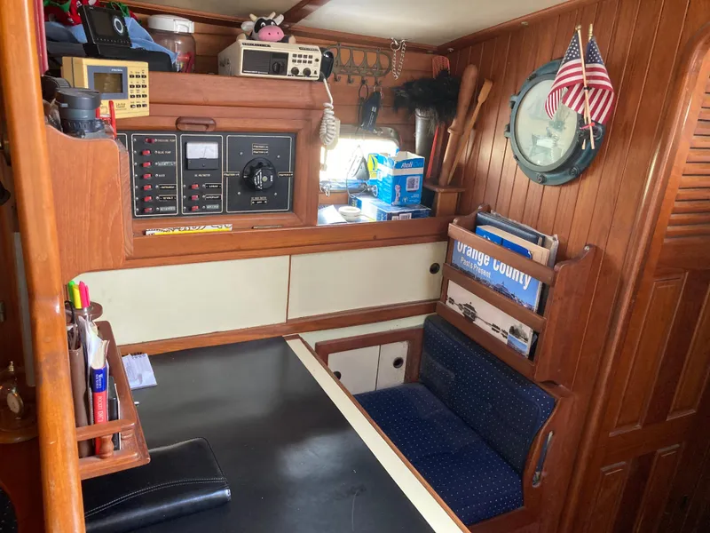 Slide: The Image of Cozy 1984 Nantucket Island 33 yacht interior with navigation equipment and seating area. - 57