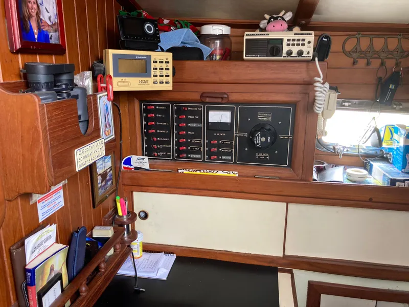 Slide: The Image of Interior of a 1984 Nantucket Island 33 boat with navigation equipment and wooden paneling. - 58