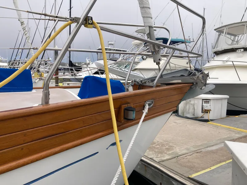 Slide: The Image of Sailboat docked at marina, Nantucket Island 33, 1984 model, wooden trim, overcast sky. - 6
