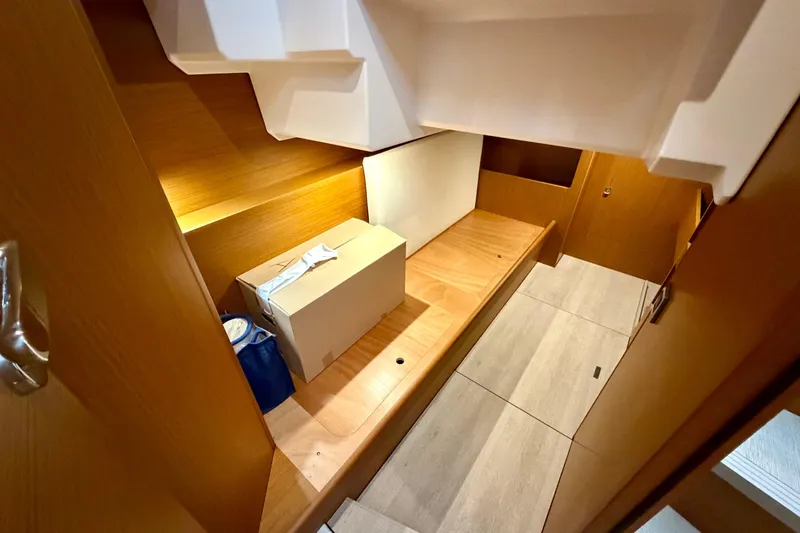 Slide: The Image of Storage compartment with blue plates in 2026 Beneteau Swift Trawler 41 Fly. - 12