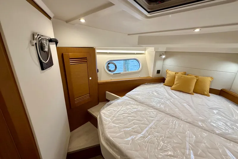 Slide: The Image of 2026 Beneteau Swift Trawler 41 Fly interior storage area with wooden finish. - 18