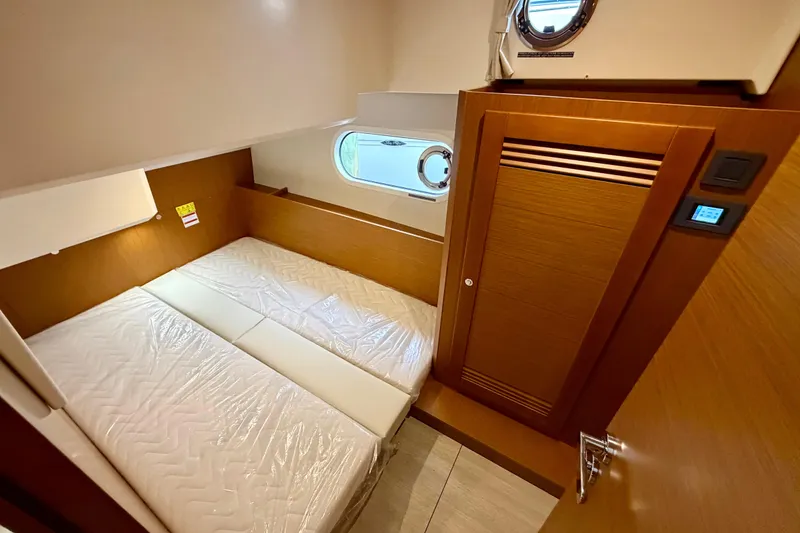Slide: The Image of 2026 Beneteau Swift Trawler 41 Fly cabin interior with bed and wooden finishes. - 21