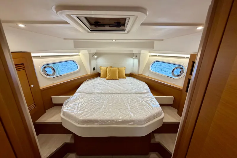 Slide: The Image of Luxurious cabin interior of 2026 Beneteau Swift Trawler 41 Fly with cozy bedding. - 22