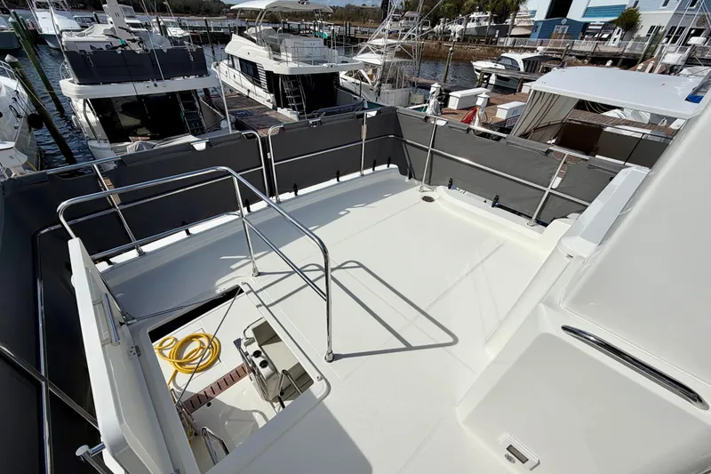 Slide: The Image of 2026 Beneteau Swift Trawler 41 Fly deck view at marina, showcasing spacious layout. - 30