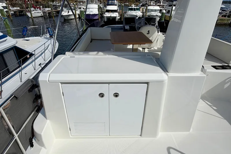 Slide: The Image of 2026 Beneteau Swift Trawler 41 Fly deck with seating and helm, docked at marina. - 31