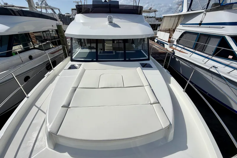 Slide: The Image of 2026 Beneteau Swift Trawler 41 Fly, docked, showcasing spacious deck and sleek design. - 33