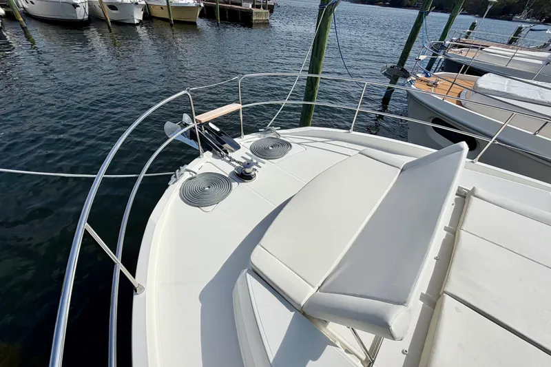 Slide: The Image of 2026 Beneteau Swift Trawler 41 Fly, bow view with sunpad and winch, docked at marina. - 34