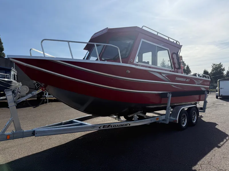The Image of 2025 Thunder Jet 24 Alexis Pro boat on trailer, red exterior, parked outdoors. - 1