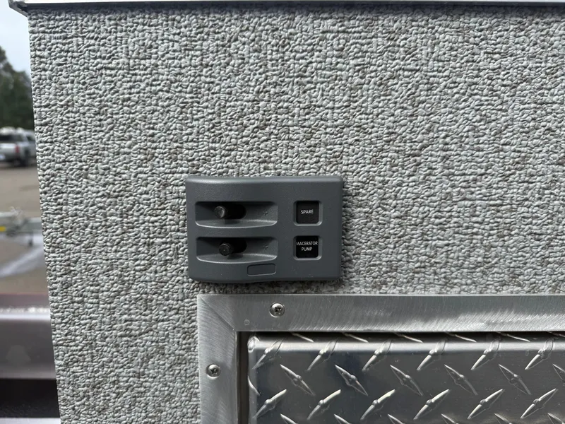 Slide: The Image of Control panel on 2025 Thunder Jet 24 Alexis Pro boat with textured surface and diamond plate detail. - 10