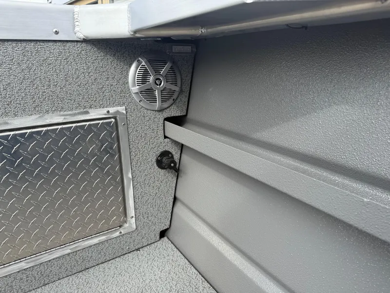 Slide: The Image of Interior of 2025 Thunder Jet 24 Alexis Pro boat with speaker and diamond plate panel. - 13