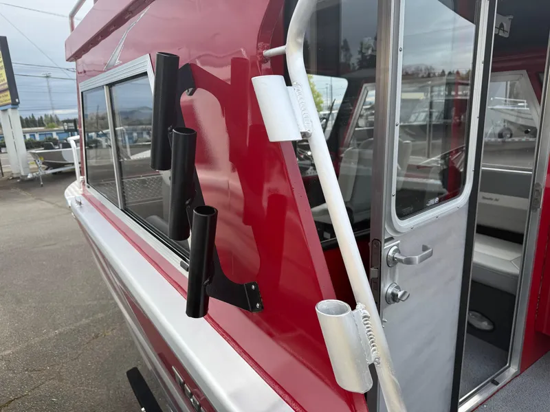 Slide: The Image of 2025 Thunder Jet 24 Alexis Pro boat with red exterior and rod holders. - 16