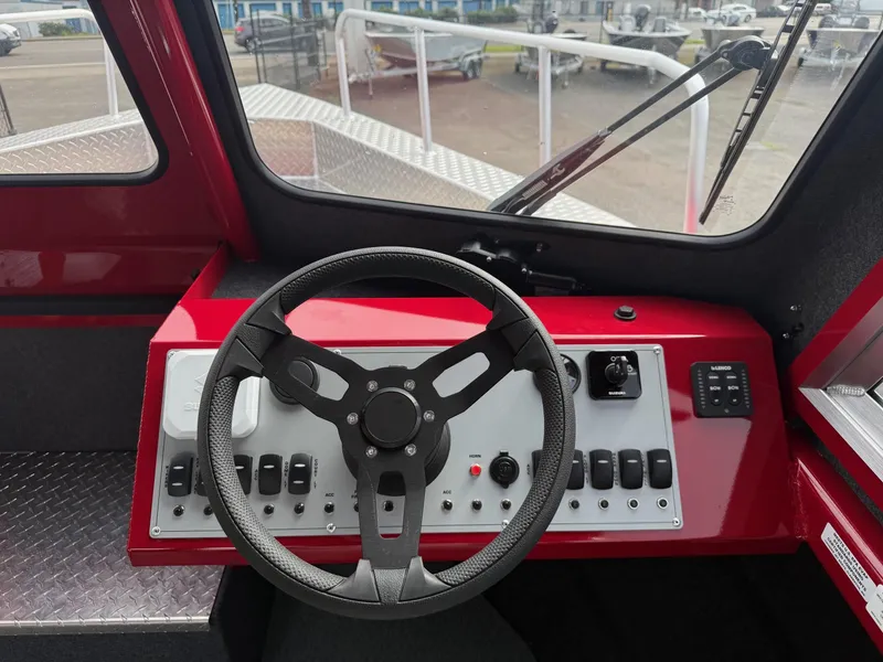 Slide: The Image of 2025 Thunder Jet 24 Alexis Pro boat dashboard with steering wheel and control panel. - 23
