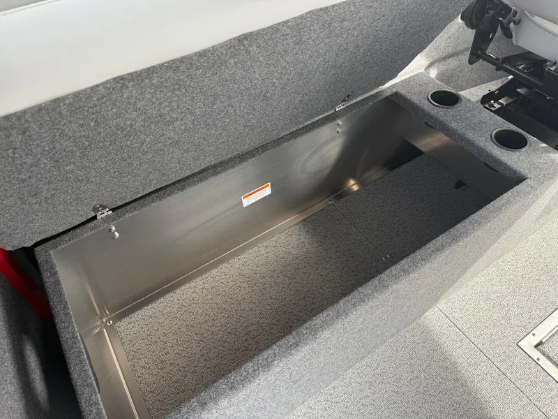 Slide: The Image of 2025 Thunder Jet 24 Alexis Pro boat storage compartment with gray interior and cup holders. - 29