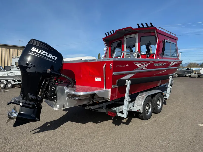 Slide: The Image of 2025 Thunder Jet 24 Alexis Pro boat with Suzuki outboard motor on a trailer. - 3