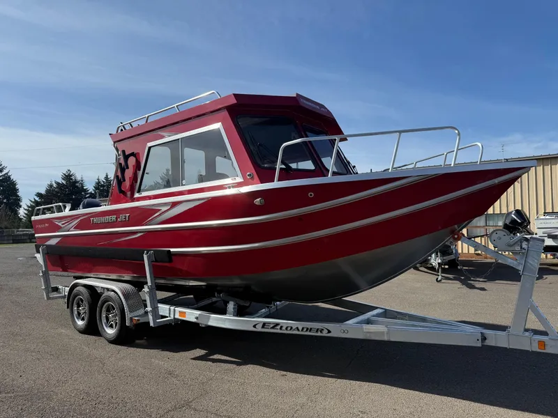 Slide: The Image of 2025 Thunder Jet 24 Alexis Pro boat on trailer, red exterior, parked outdoors. - 4