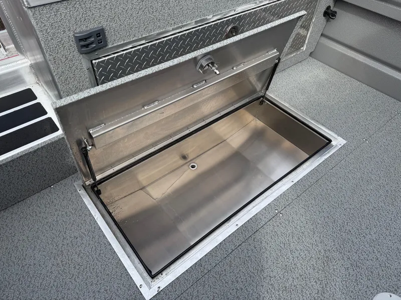 Slide: The Image of Open storage compartment on 2025 Thunder Jet 24 Alexis Pro boat deck. - 9
