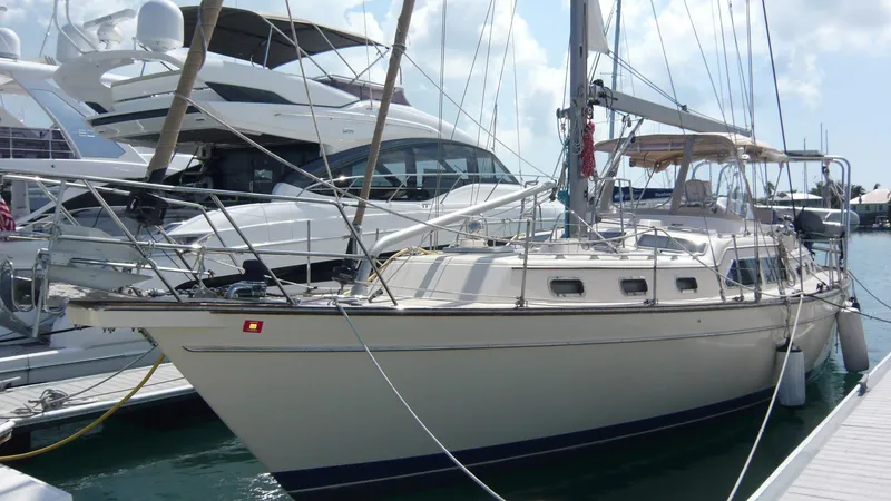 Slide: The Image of 2008 Island Packet 465 sailboat docked at marina, surrounded by other yachts. - 1