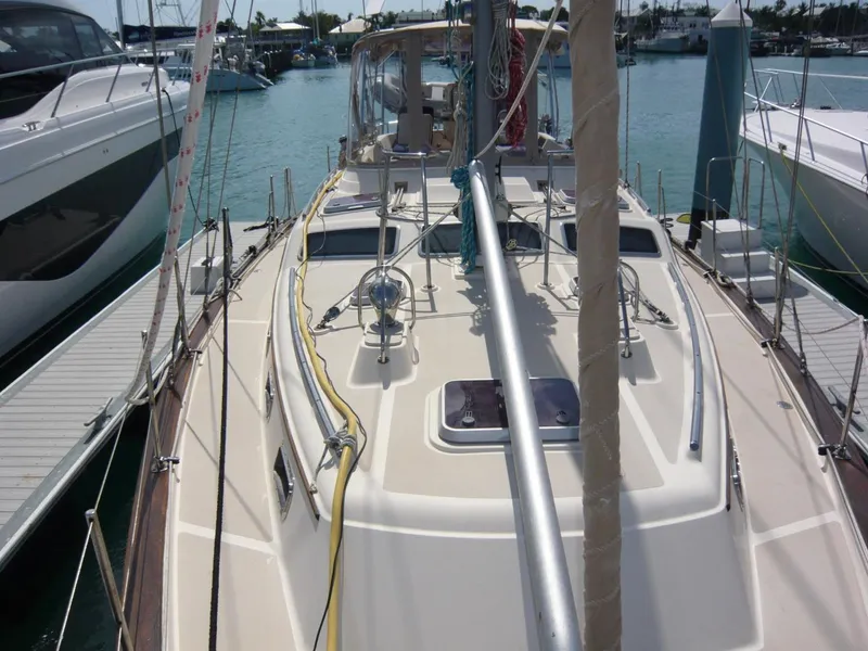 Slide: The Image of 2008 Island Packet 465 sailboat docked in a marina, showcasing deck and rigging. - 10