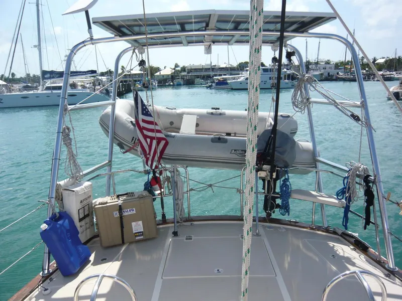 Slide: The Image of 2008 Island Packet 465 sailboat with dinghy and American flag in marina. - 11