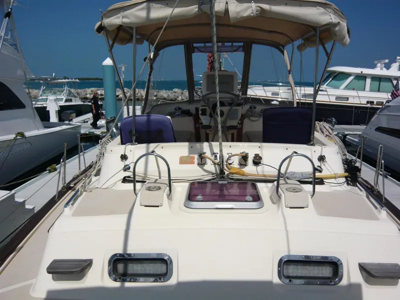 Slide: The Image of 2008 Island Packet 465 yacht docked at marina, featuring spacious deck and cockpit. - 13